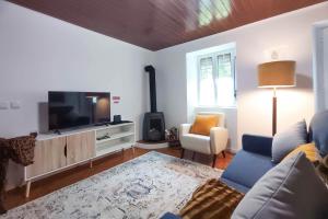 Una sala de estar con un sofá y un televisor de pantalla plana. en Echoes of Nature, en Sete Cidades