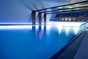 a swimming pool with blue lights on the water at Eden Resort & Spa in Mielno