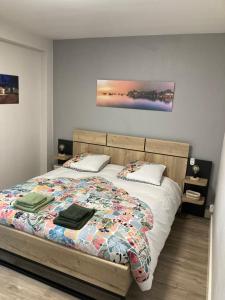 a bedroom with a bed with two pillows on it at Résidence le 46 in Concarneau