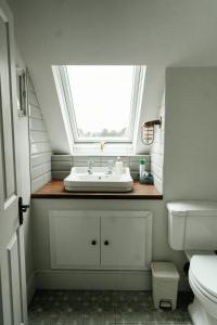 a bathroom with a sink and a window at Louisa's Loft in Enniskillen