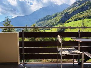 a chair on a balcony with a view of mountains at Valere C 244 in Leukerbad