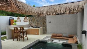 a patio with a bar and a swimming pool at JBS Villa in Yogyakarta