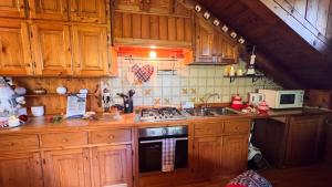 a kitchen with wooden cabinets and a stove top oven at Chalet Stravedo by Ca-Sa Check in Villanova