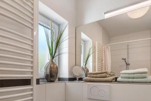 a bathroom with a mirror and a sink with towels at Haus Stiegeler - Gottfried Beck in Freiburg im Breisgau +78 photos