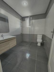 a bathroom with a toilet and a sink at Charming Villa in Midoun, Tunisia with Private Entrance and Stunning Garden View in Al Maqārisah