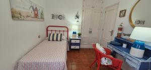 a small bedroom with a bed and a desk at puerto de la cruz playa jardin in Puerto de la Cruz +4 photos