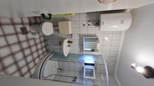a small bathroom with a sink and a mirror at House Maja in Jadrija