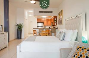 une chambre avec un grand lit blanc et une cuisine dans l'établissement Amazing Studio with Terrace Overlooking the Ocean, à Nuevo Nayarit