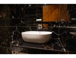 a bathroom with a white sink on a counter at Hotel Eminence inn Punjab in Mohali