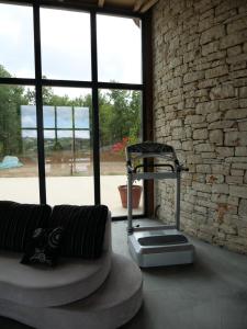a living room with a couch and a brick wall at Hani i Qerosit in Kuçovë
