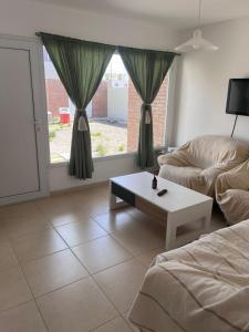 a living room with a couch and a coffee table at Santa Lucía in Playa Unión