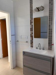 a bathroom with a sink and a mirror and a shower at Santa Lucía in Playa Unión