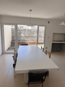 a large white table in a room with a large window at Santa Lucía in Playa Unión +4 photos