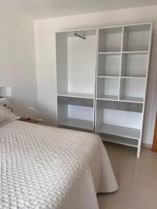 a bedroom with a bed and a book shelf at Santa Lucía in Playa Unión