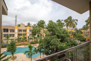 a view of the pool from the balcony of a resort at Rehano by Leo Homes - 2BHK Flat near Anjuna Beach in Anjuna