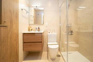 a bathroom with a toilet and a shower and a sink at Numavante By Silastur in Gijón
