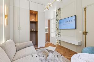 a living room with a couch and a tv on a wall at Charming Levallois-Perret studio near Paris in Levallois-Perret
