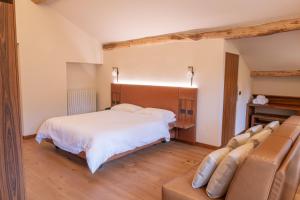a bedroom with a bed and a couch at Hotel Rosa delle Alpi in Esino Lario +22 photos