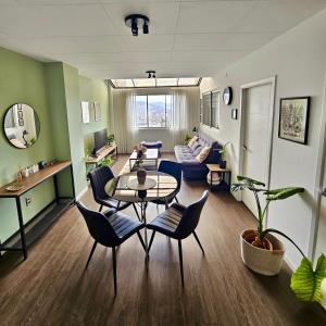 a living room with a table and chairs and a couch at Brand-new 2 bedroom apartment Sopocachi in La Paz