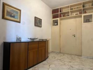 a room with a wooden desk and a closet at ROOF and SKY SUITE 5 FLOOR in SORRENTO CENTER in Sorrento +9 photos