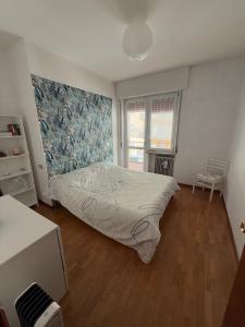Un dormitorio con una cama grande y una ventana. en Maison da Mary, en Longarone
