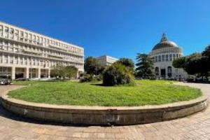 a large building with a grassy area in front of a building at Don Bosco Holiday Home in Rome