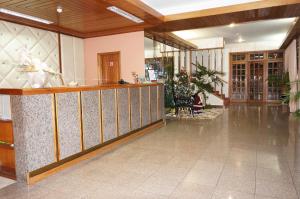 a lobby with a bar in the middle of a building at Hotel Contriz in Póvoa de Varzim