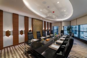 a dining room with long tables and chairs at Ascott Corniche Al Khobar in Al Khobar +124 photos