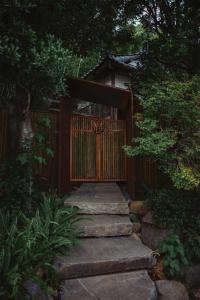 a gate with a stone path leading to a garden at 回青橙 daidai in Atami