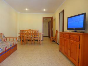 a living room filled with furniture and a tv at Apartamentos Salou Centro in Salou