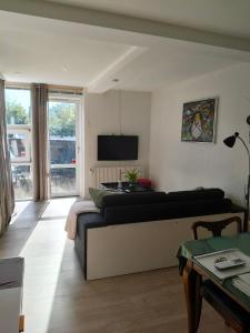 a living room with a couch and a tv at Håstrups Natur Perle in Fåborg +25 photos