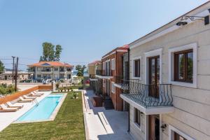 arial view of a building with a swimming pool at Anthelia in Skala Potamias