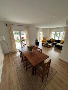 a living room with a wooden table and chairs at Solar da Sobreda in Sobreda