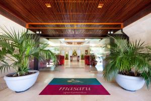 a lobby with two potted plants and a rug at Apartamentos Masaru in Puerto de la Cruz