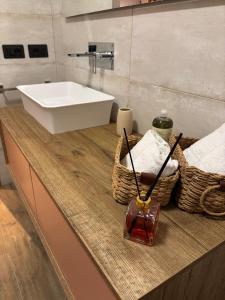 a bathroom with a sink and baskets on a counter at Il Tiglioré in Poderi Rancoli +36 photos