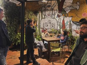 a man talking on a cell phone in a restaurant at Hostel Bohemian in Montevideo