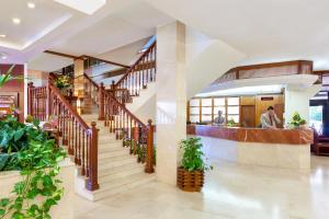 a lobby of a building with stairs and plants at Apartamentos Masaru in Puerto de la Cruz