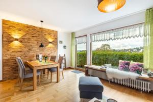 a dining room with a table and a large window at Chalet Am Scheidt in Medebach
