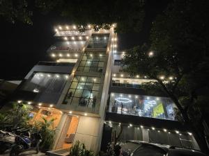 a tall building with lights on it at night at Hare Rama Guest House in Dehradun