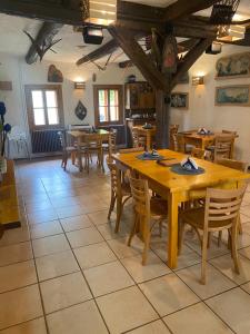 a dining room with wooden tables and chairs at Karczma Siedlisko Pokoje Gościnne 