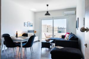 a living room with a table and a couch at Phoenix 2-Bedroom Apartment in Larnaca