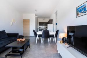 a living room with a couch and a table at Phoenix 2-Bedroom Apartment in Larnaca