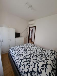 a white bedroom with a black and white bed at Uscio Natura in Uscio