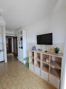 a living room with a television on a shelf at Uscio Natura in Uscio