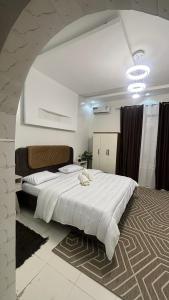 a bedroom with a large white bed in a room at Chambre meublée in Dakar +8 photos