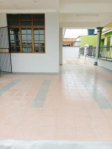an empty floor of a building with a tile floor at Yesh Homestay in Bahau
