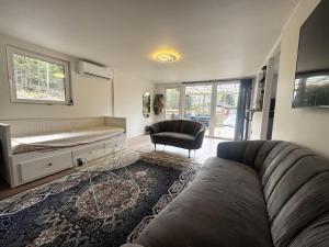 a living room with a couch and a chair at Cozy holiday home near the lake, perfect for the family in Bredared
