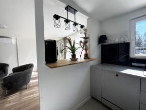 a kitchen with a counter and a chair and a window at Cozy holiday home near the lake, perfect for the family in Bredared +4 photos