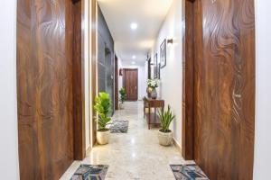 a hallway with wooden walls and potted plants at FabHotel Hari Residency in Haridwār