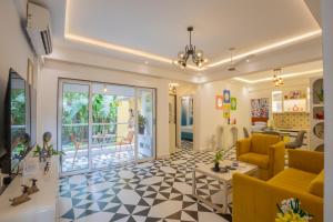 a living room with a couch and a table at Casa Leo by Leo Homes 2BHK Flat near Anjuna Beach in Anjuna